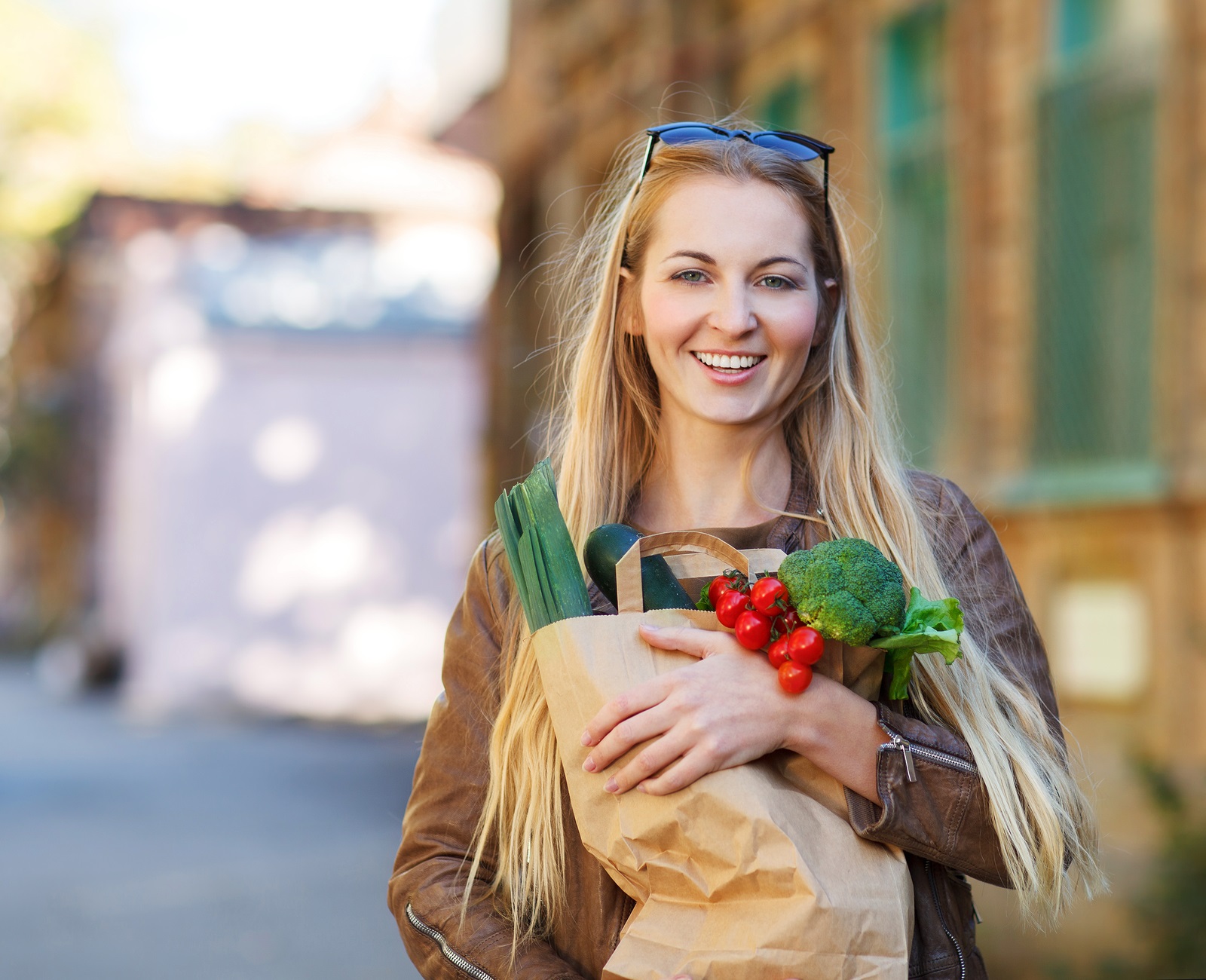 Young happy woman with shopping bags outdoors